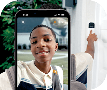 A young boy entering his code in the keypad and showing his face on a phone